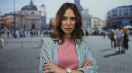 Devojka u rozoj majici i teksas košulji prekrštenih ruku