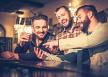 stockphotocheerfuloldfriendshavingfunwithsmartphoneanddrinkingdraftbeeratbarcounterinpub390074167.jpg