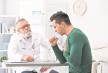 stockphotocoughingyoungmanvisitingdoctoratclinic1119954077.jpg