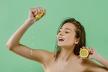 stockphotojoyfulyoungwomanmakesjuicefromlemonandholdinglemonnearheadhealthylifestyle619408631.jpg