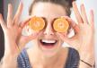 stockphotoyoungbrunettewomanholdingtangerinesinsteadofeyeslaughsandenjoyslifeharshprocessing370031846.jpg