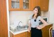 stockphotoportraitofabeautifulbrunetteinwomaninamodernkitchen89344663.jpg