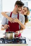 stockphotoportraitofhappyyoungcouplecookingtogetherinthekitchenathome454744423.jpg