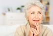 stockphotothoughtfulseniorladysittingathomewithherfingerstoherchinreminiscingandrecallingfond152525405.jpg