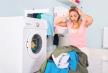 stockphotoyoungunhappywomanlookingatpileofdirtyclothesnearwashingmachineatlaundryroom555960160.jpg