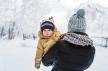 fraj-stockphotoaboysonlooksoutfrombehindmotherthemothercarriesthebabyinwinterparkcloseupportrait1194792832.jpg