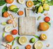 stockphotovarietyoffreshcitrusfruitformakingjuiceorsmoothieandwoodenchoppingboardoverlight604321580.jpg