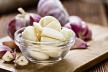 stockphotopeeledgarliccloseupshotonvintagewoodenbackground241855408.jpg