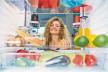 stockphotowomanstandinginfrontofopenedfridgeandtakingorangefruitfridgefullofgroceriespicture1323588791-1199-800.jpg