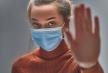 stockphotostopthevirusandepidemicdiseaseshealthywomaninbluemedicalprotectivemaskshowinggesture1633291840.jpg