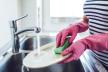 stockphotocroppedimageofattractiveyoungwomaniswashingdisheswhiledoingcleaningathome772667173.jpg