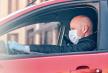 stockphotobanneramandrivingacarinaprotectivemedicalmaskandglovessafedriveinataxiduringa1699744162.jpg