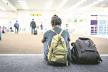 0808stockphotoyoungwomanwithbackpackinairportnearflighttimetabledelayedairplaneconcept1165843993.jpg