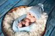 stockphotolittlebabyboywithknittedhatinabaskethappilysmilingandlookingatcameraisolated765918223.jpg