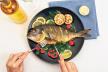 stockphotofemalehandscuttingtastyfishonplate510597505.jpg