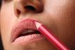 stockphotomakeuplipscloseupofbeautifulyoungwomanappliescolorcontourlippenliplinergirl517945147.jpg