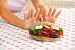 ne-doruckujte-pre-vadjenja-krvii-stockphotofemalehandsrefusingbigmeatsandwichwithhamandcheese57784627.jpg