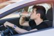 stockphotohandsomeyoungmanorteenagerdrivingcaranddrinkingwaterfromplasticbottle275461517.jpg