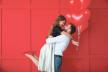 stockphotohappyyoungcouplewithheartshapedballoonsoncolorbackgroundvalentinesdaycelebration1573448737.jpg