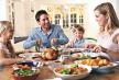 stockphotohappyfamilyhavingroastchickendinnerattable70256782.jpg