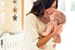 stockphotoyoungmotherholdingherbabyinthebedroom490357867.jpg