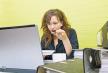 stockphotocaucasianyoungwomaneatingandworkingonherlaptopcomputeratherdesk143818984.jpg