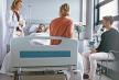 stockphotofamilyandfriendsvisitingpatientinhospitalwardandtalkingwithdoctorfemalephysician744969181.jpg