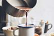 stockphotocupofhotcocoaonthetablewomanpouringcocoaintothemetalmug742986514.jpg