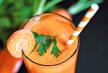 stockphotoglassesofcarrotjuicewithvegetablesontablecloseup480296662.jpg