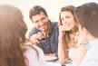 stockphotogroupofhappyyoungfriendsenjoyingdinneroutdoor146199587.jpg