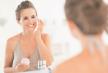 stockphotohappyyoungwomanapplyingcreaminbathroom170784851.jpg