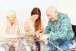 stockphotofamilywithseniorsandgranddaughterhavefunplayingpuzzleathome796306306.jpg