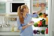 stockphotowomantakingfreshmeatoutofrefrigeratorinkitchen1234001653.jpg