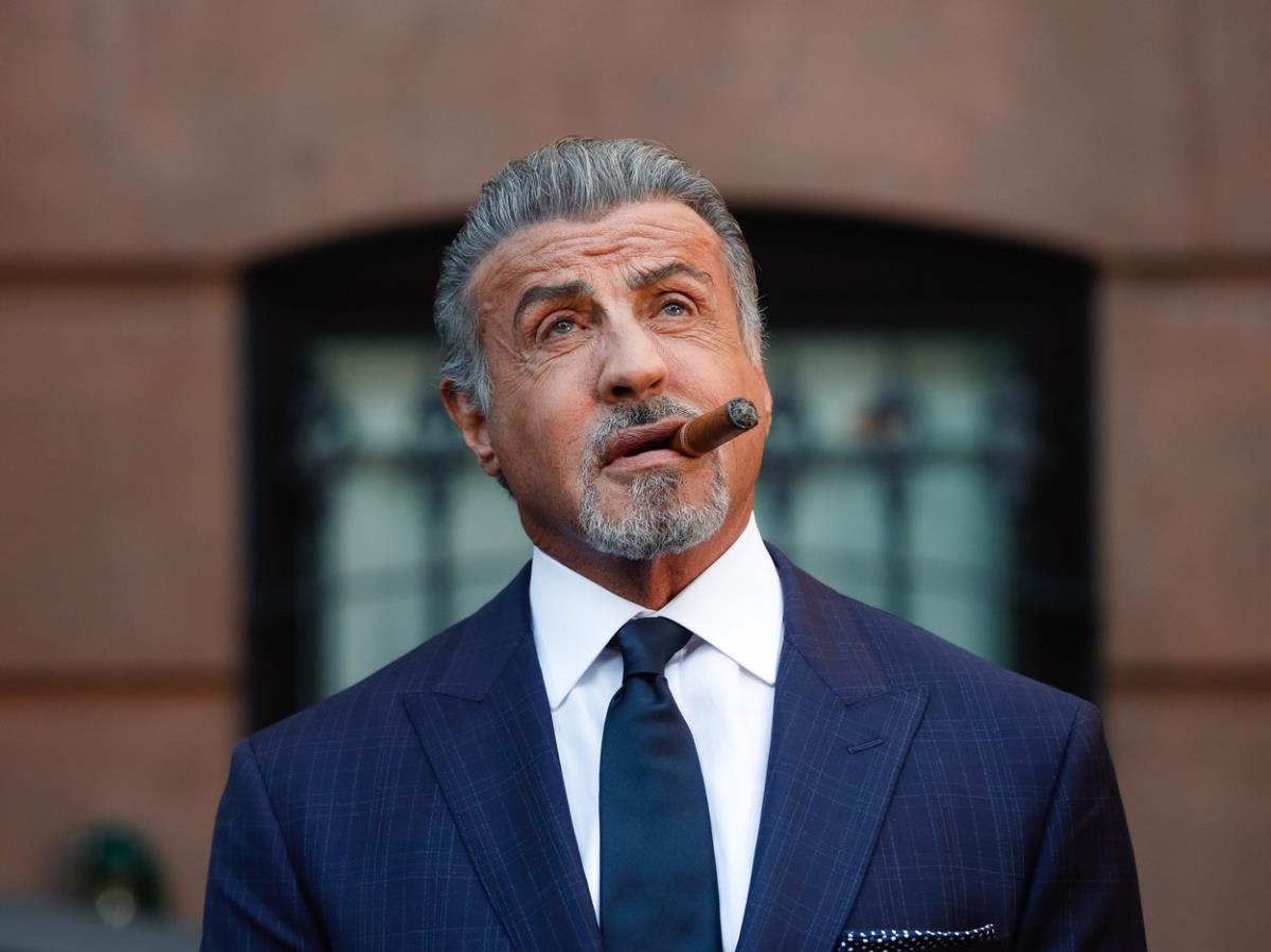 Silvester Stalone u plavom odelu sa tompusom u ustima