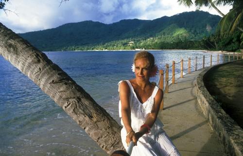 Jolanda Điljoti Dalida sedi na drvetu kraj vode u beloj haljini