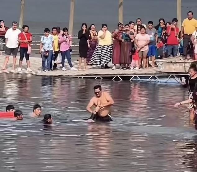 96549283-14534787-A_member_of_a_local_Christian_church_drags_the_body_of_Miguel_St-a-2_1742918226914 copy.jpg