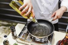 stockphotochefpreparingoliveoilinapanformakingrosemaryoil589858880.jpg