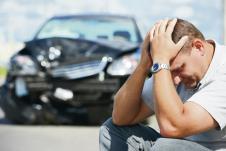 stockphotoadultupsetdrivermaninfrontofautomobilecrashcarcollisionaccidentincityroad151794464.jpg