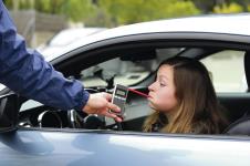 stockphotodrinkanddrivecrashedyoungfemaledriverbeingsubjecttotestforalcoholcontentwithuseof561131515.jpg