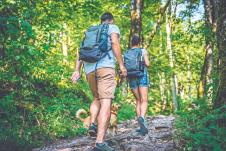 stockphotocouplewithasmallyellowdoghikinginforest719455552.jpg