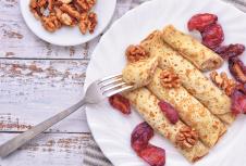 stockphotopancakeswalnutplumspancakeswithfillingonawhiteplatewoodbackgroundrusticstyle1362476270.jpg