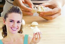 stockphotowomanpeelinggarlicbyhandforcooking578728033.jpg