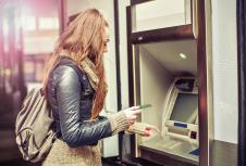 stockphotoyoungwomanwithdrawingmoneyfromcreditcardatatm401897728.jpg