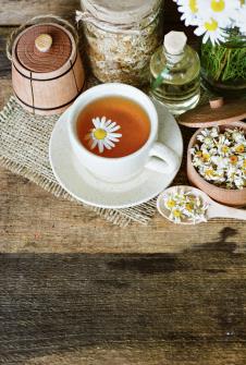 stockphotocupofherbalchamomileteawithcamomiledryblossomsdriedcamomileflowersdoctortreatment722724046.jpg