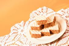 stockphotofilledwafercakesweetdessertisonplateonorangebackground1382406608.jpg