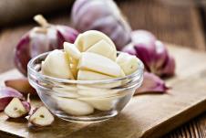 stockphotopeeledgarliccloseupshotonvintagewoodenbackground241855408.jpg