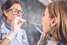 0803-stockphotofemalepediatricianusingaswabtotakeasamplefromapatientsthroat670245910.jpg