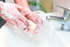 stockphotoamanwasheshishandswithsoap1612828015.jpg