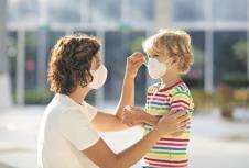 stockphotofamilywithkidsinfacemaskinshoppingmallorairportmotherandchildwearfacemaskduring1632557005.jpg