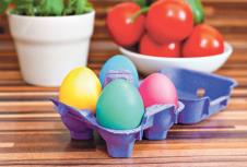 stockphotopurpleeggcontainerwithmulticoloredeastereggs1696670722.jpg